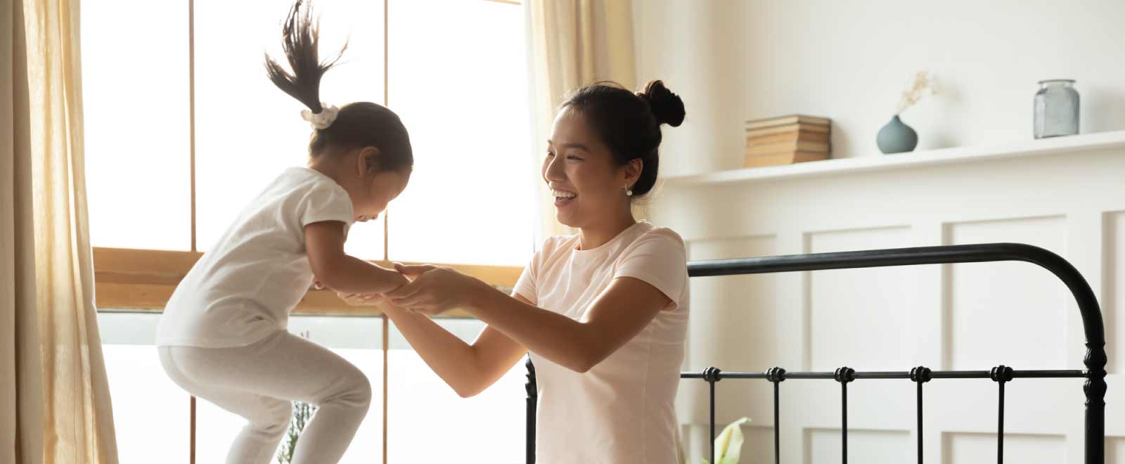 Mother playing with daughter, feeling financially safe.