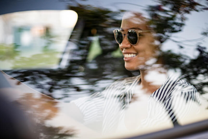 happy woman driving car