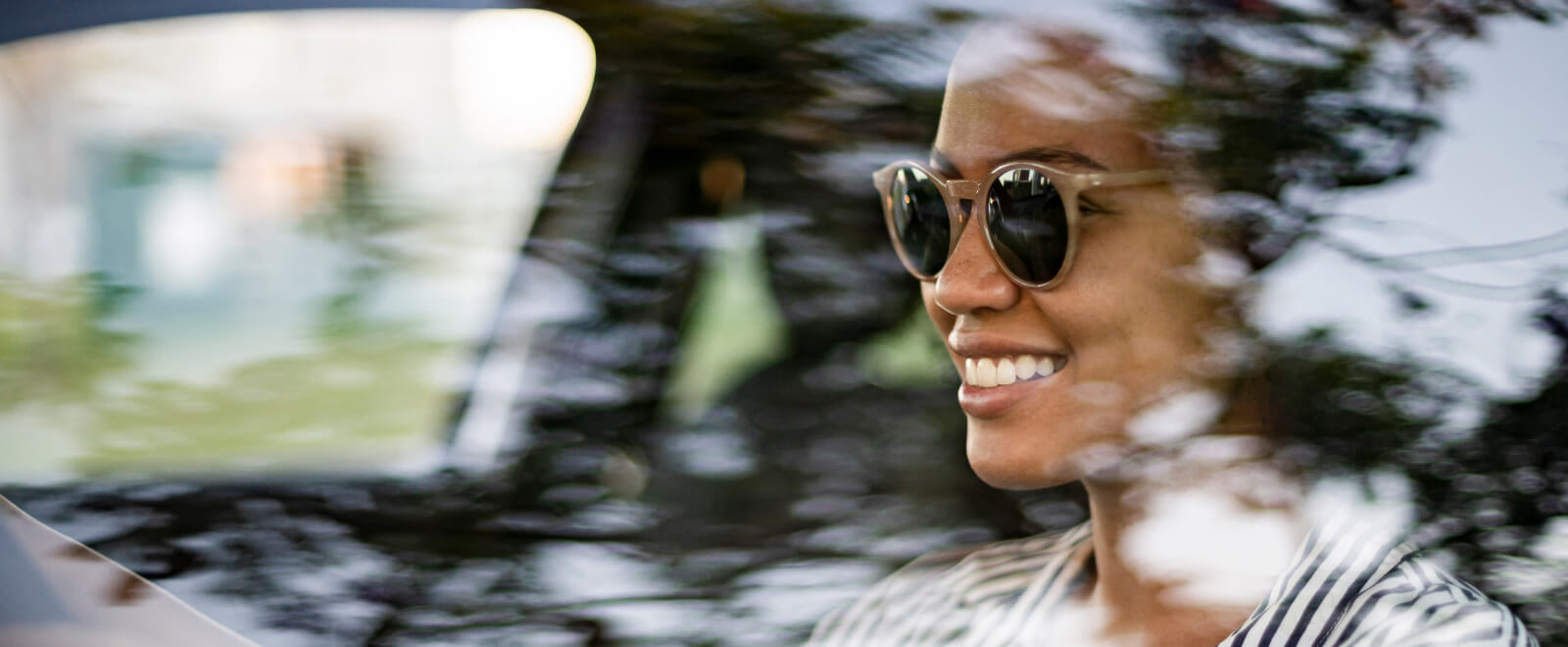 Happy woman driving her car.