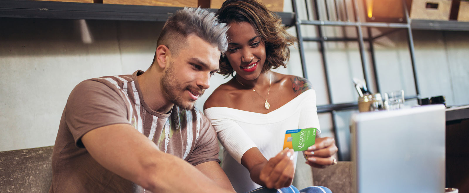 young couple holding KEMBA credit card