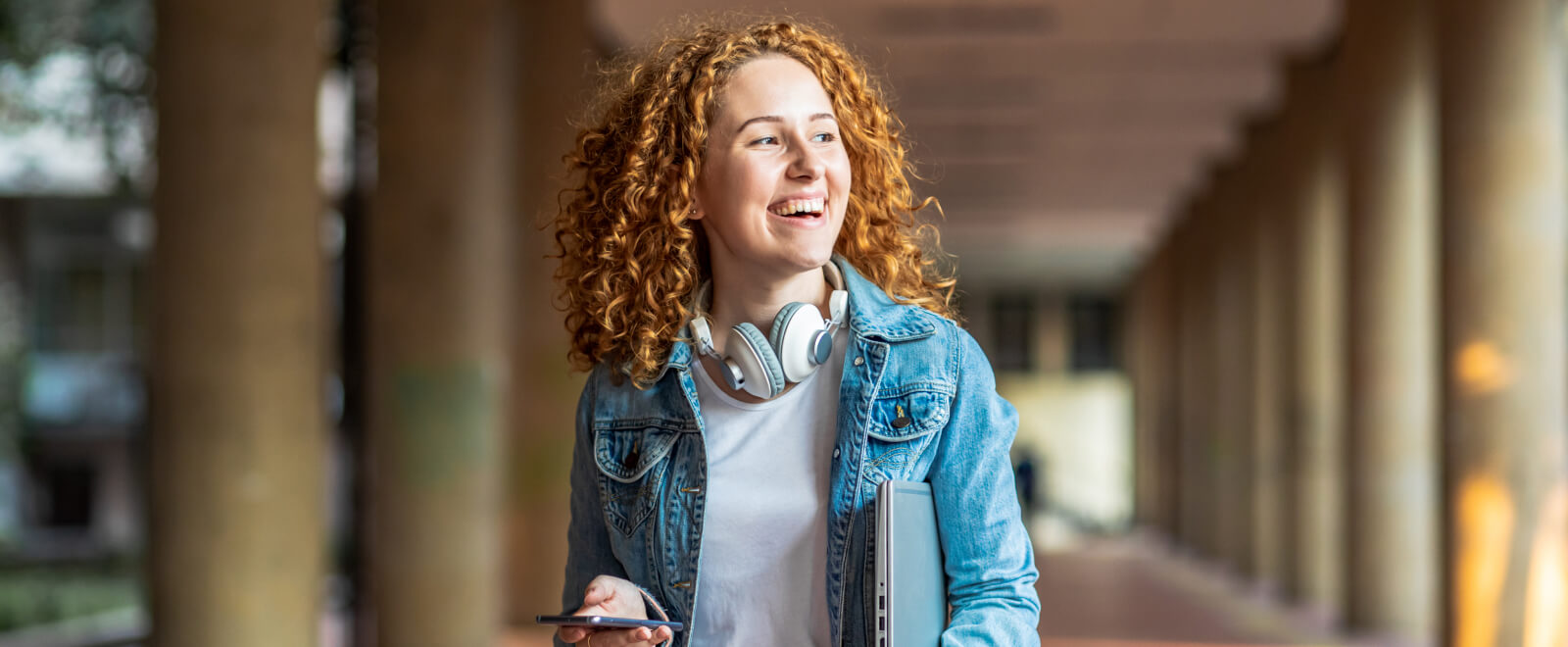 Young student outside smiling.