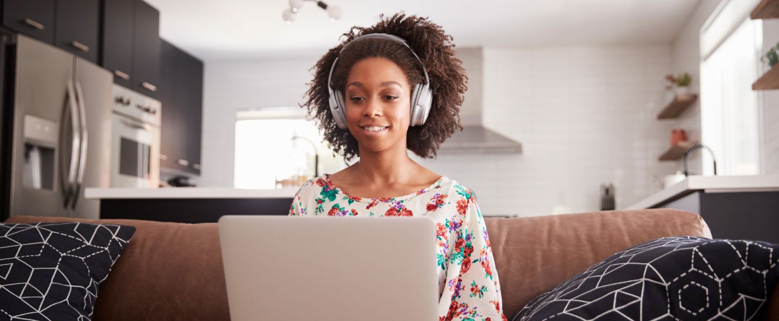 young woman working on computer with headphones