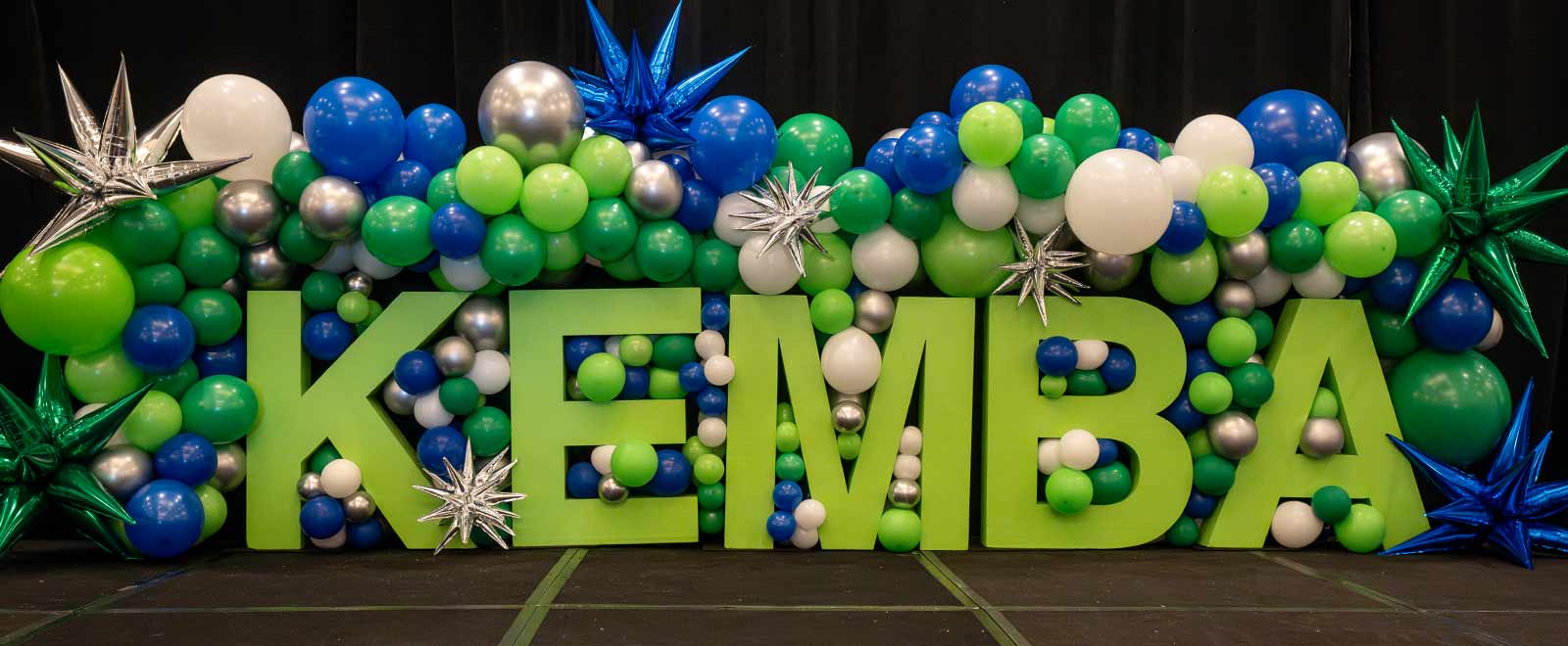 KEMBA letters and balloon display at an All-Associate conference
