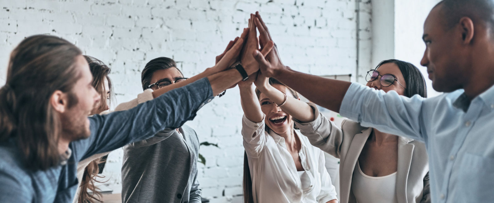 group of diverse people high-fiving