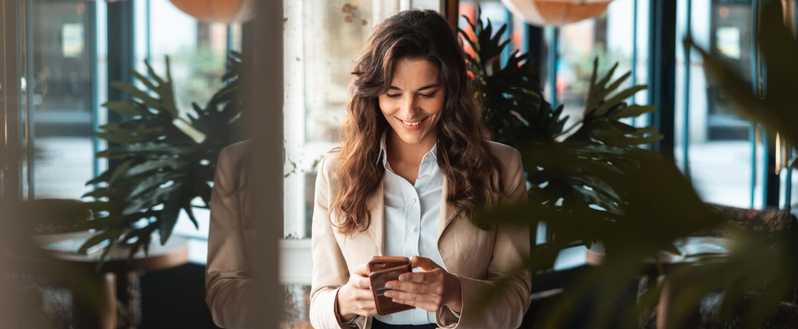 smiling woman using cell phone