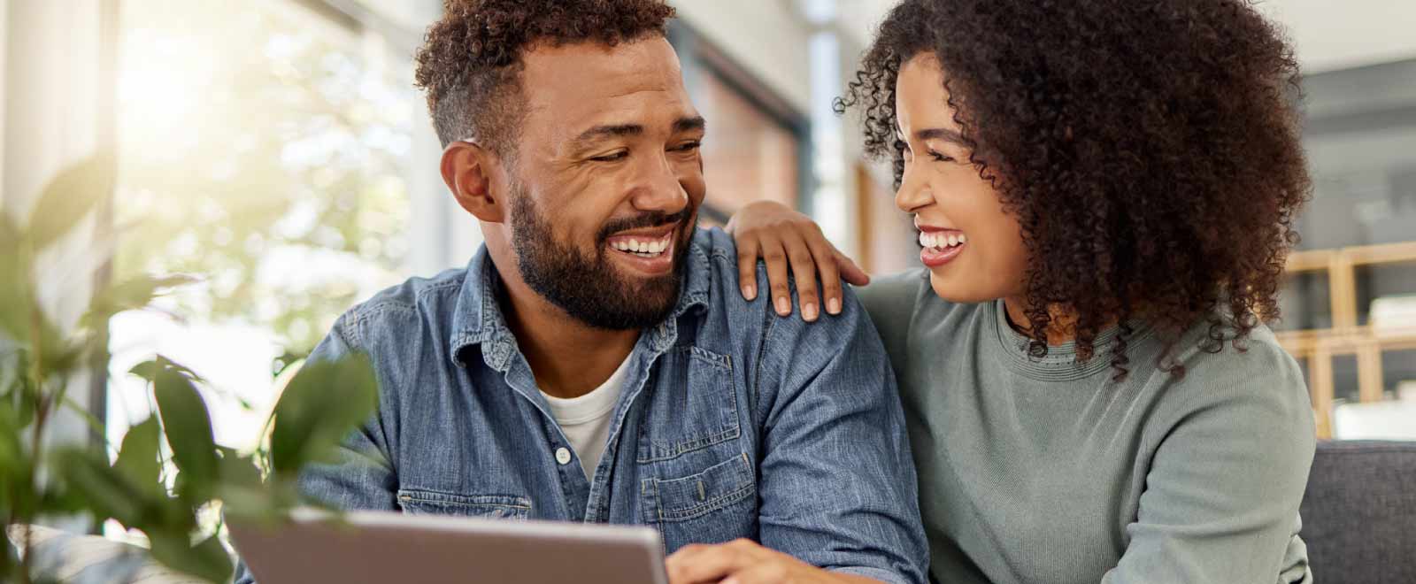 Couple reviewing options to save money by refinancing their auto loan