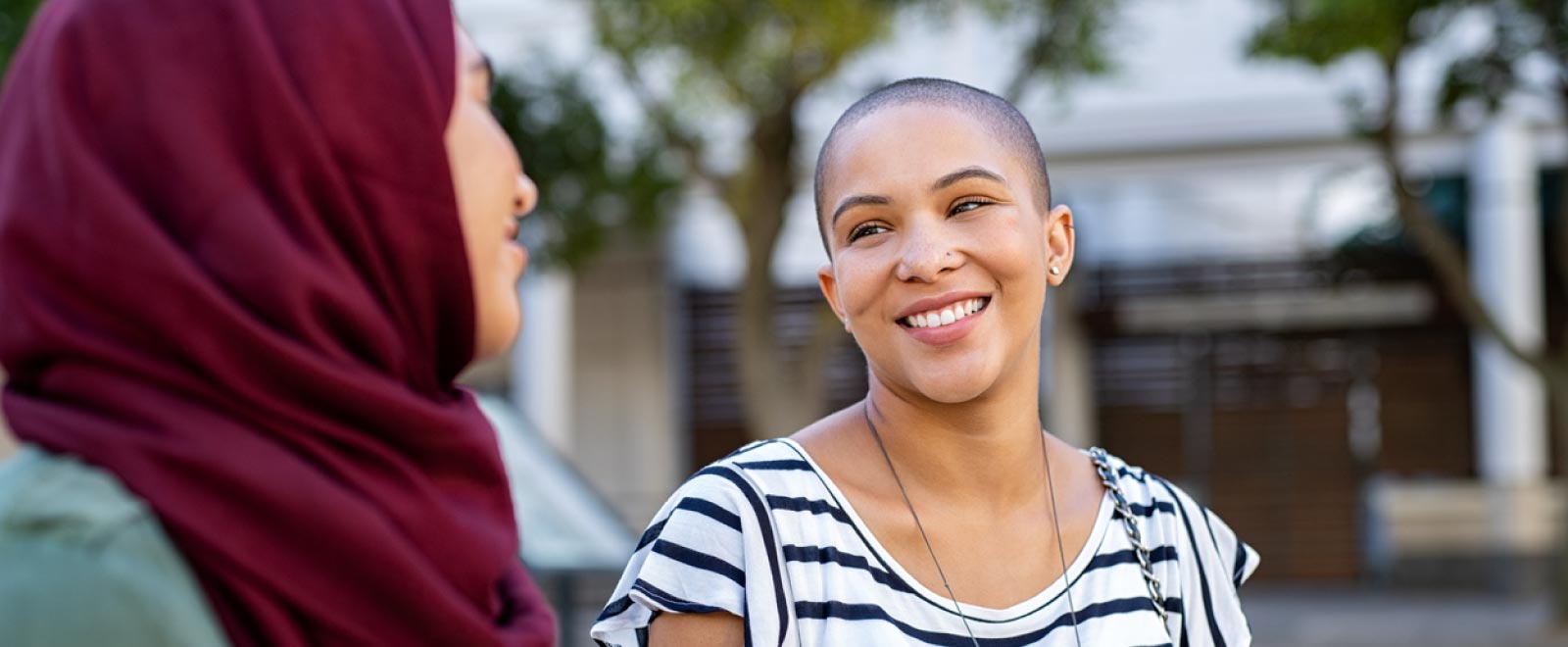 Two women smiling at each other.