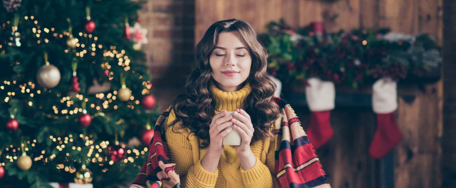 Person relaxing by holiday fireplace, symbolizing certainty in saving with a KEMBA certificate.
