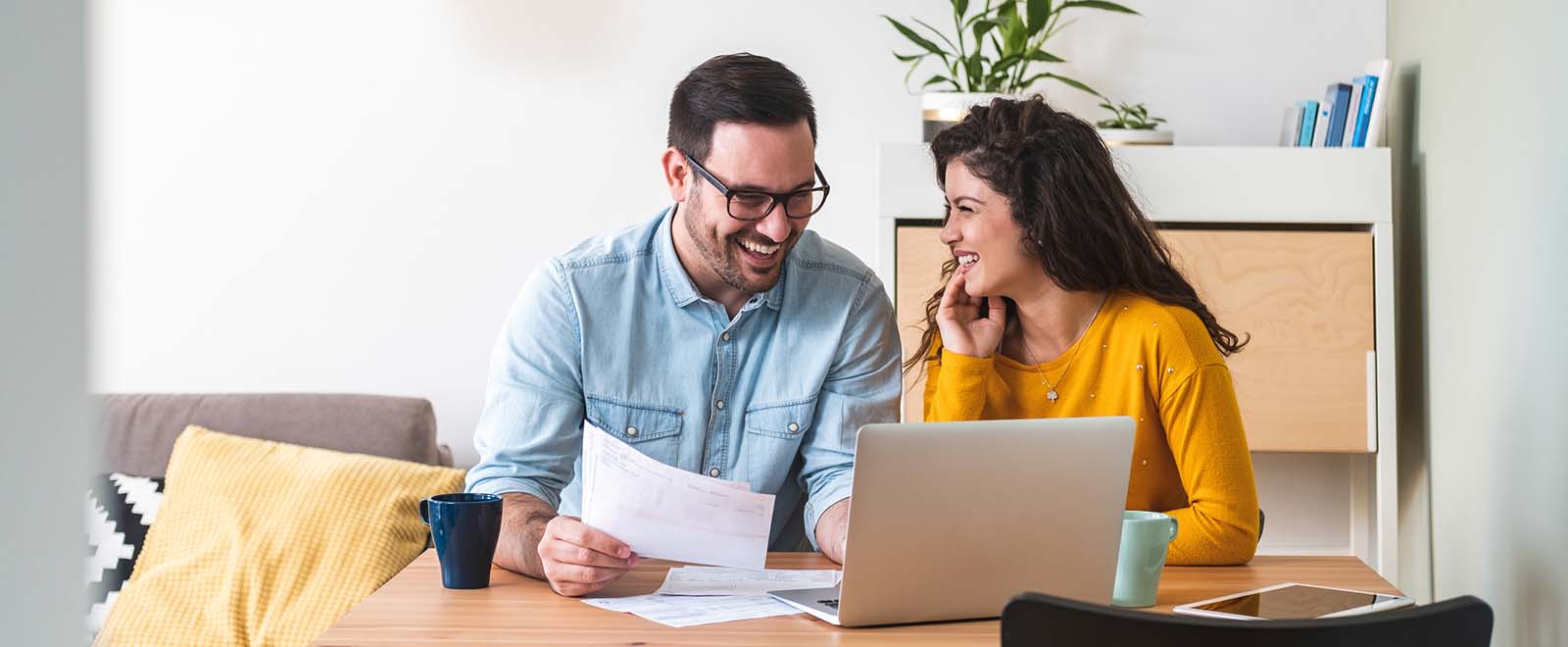 Couple manages financial wellness by paying utility bills.