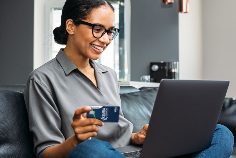 Woman manages digital banking with new KEMBA Signature credit card.