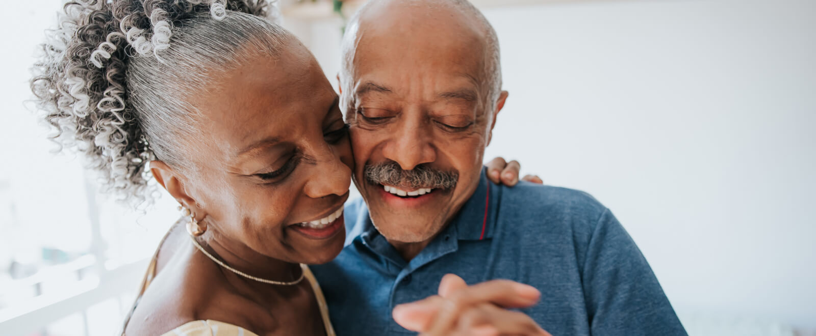 A close up of a mature couple dancing.