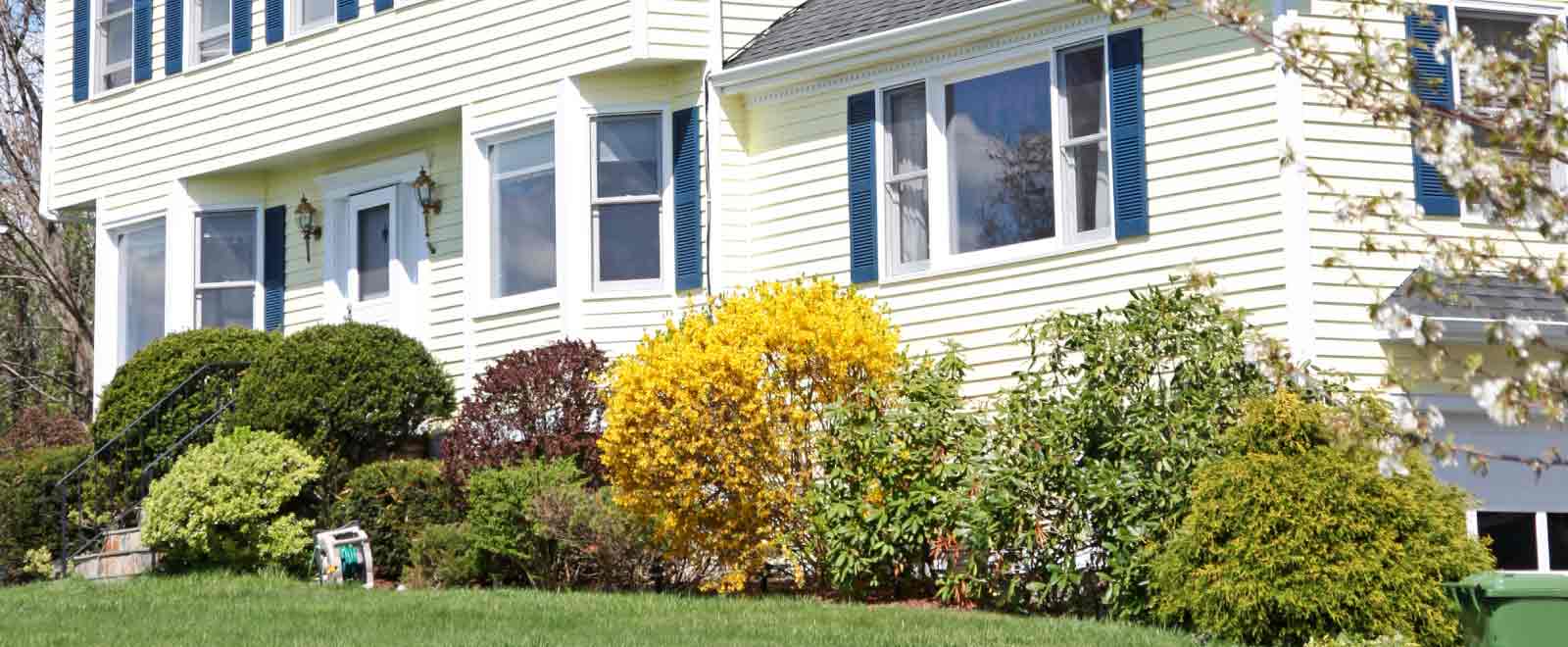 A yellow New England-style colonial home purchased with assistance from the KEMBA Financial Credit Union mortgage team.