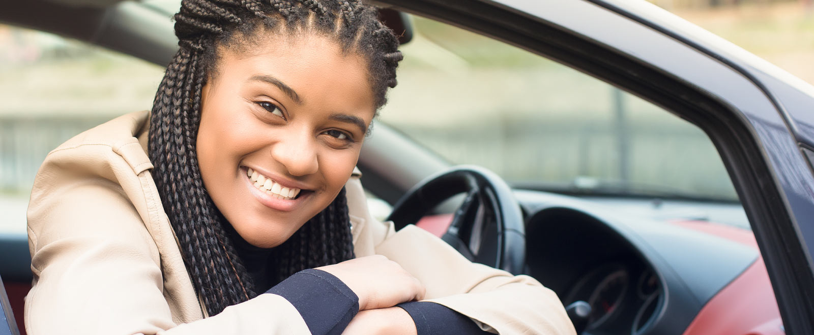 woman sitting in car smiling