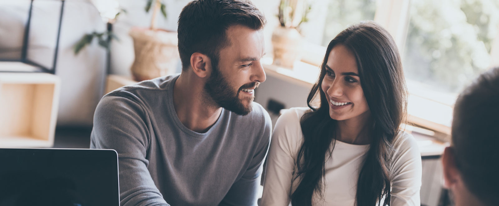 couple smiling while in meeting