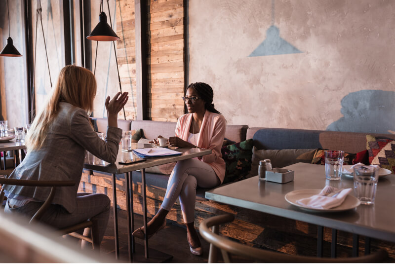 two professional woman having a lunch meeting