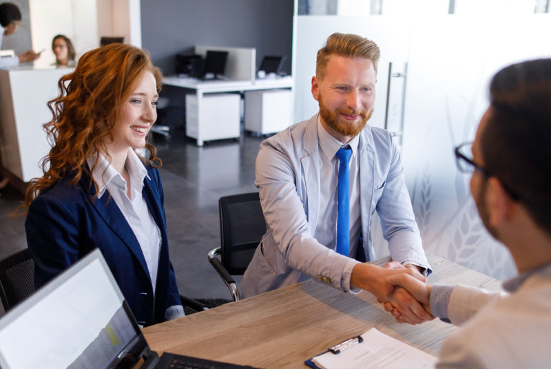 business partners shaking business expert's hand