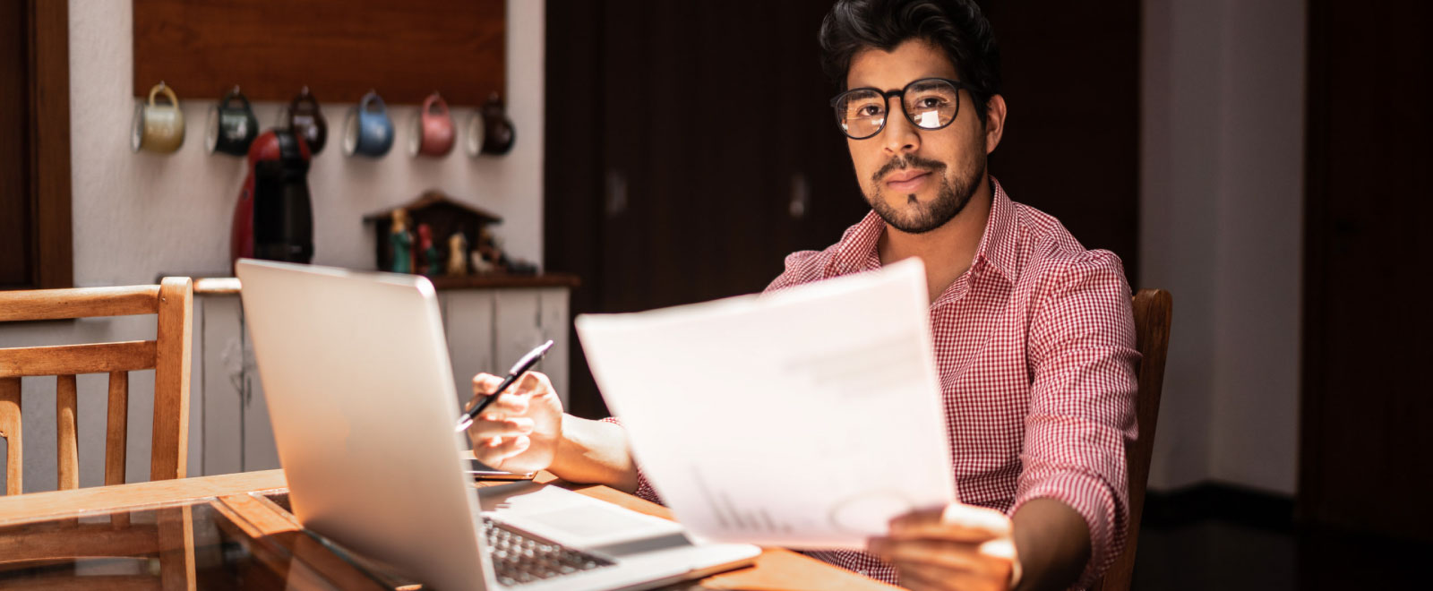 hopeful man reviewing finances on computer